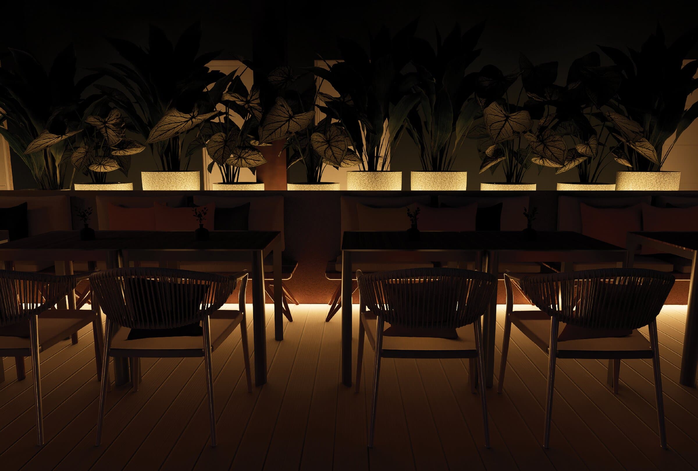 The restaurant at Dimora Blu — candlelit tables, planted wall, warm interiors